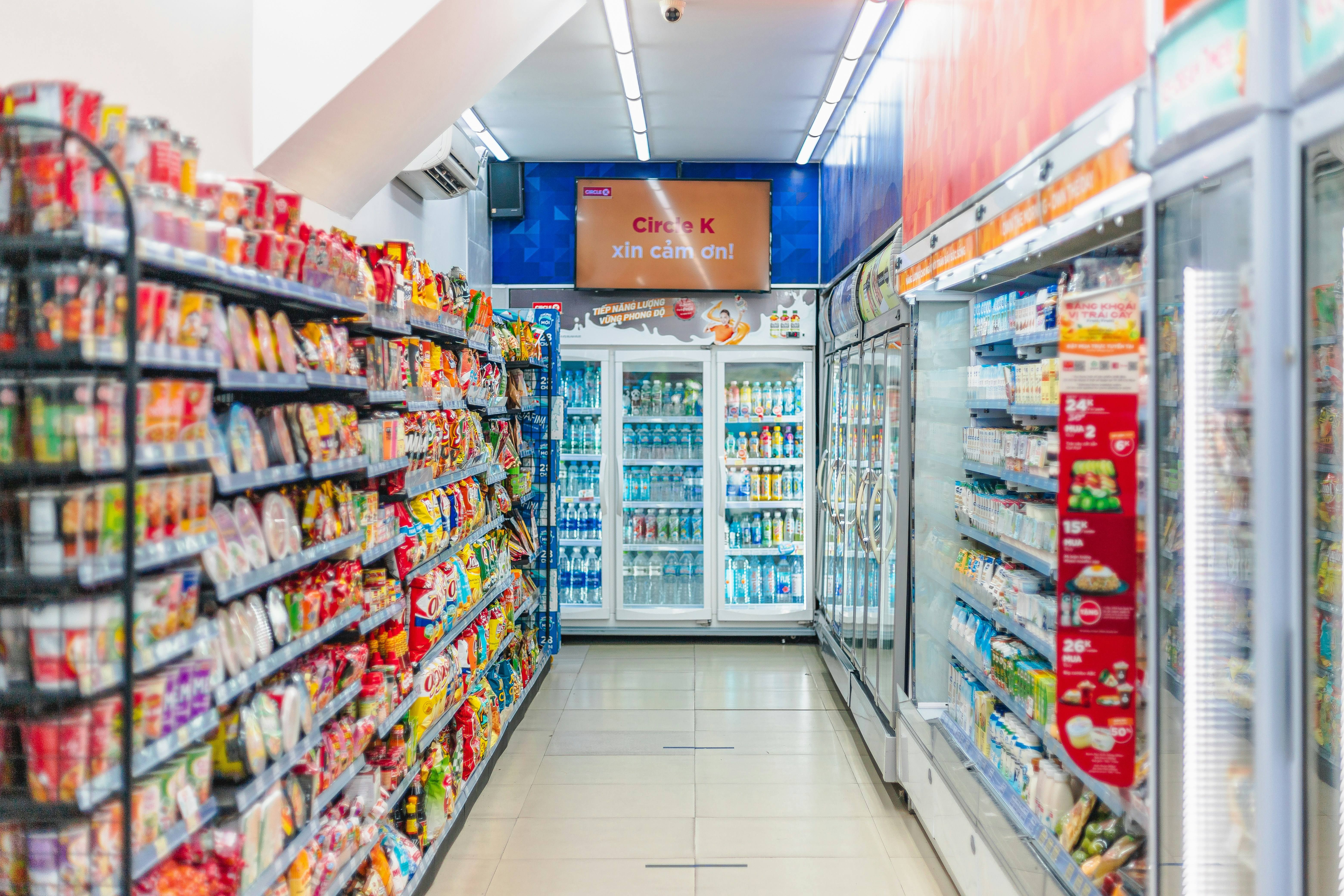 Colorful convenience store with refrigerators and product shelves